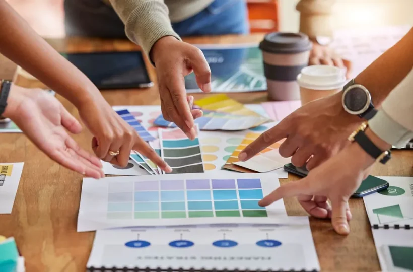 Creative team choosing brand colors from color palette options on a table